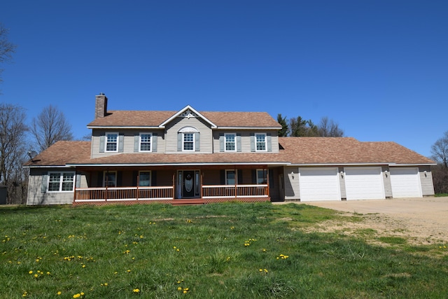 view of front facade featuring a porch, a garage, and a front yard