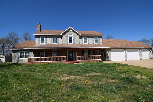 view of front facade featuring a porch, a garage, and a front lawn