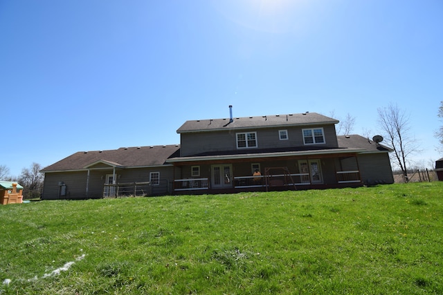 rear view of house with a lawn