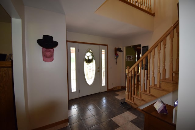 foyer with dark tile patterned flooring