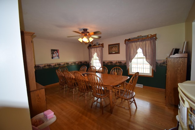 dining area featuring hardwood / wood-style floors and ceiling fan