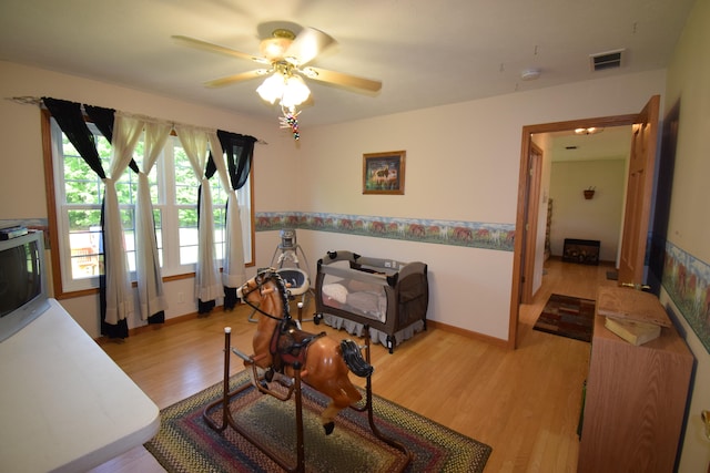 interior space with ceiling fan and light hardwood / wood-style floors