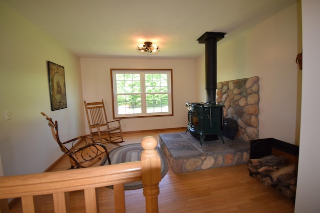 living room featuring light hardwood / wood-style floors and a wood stove