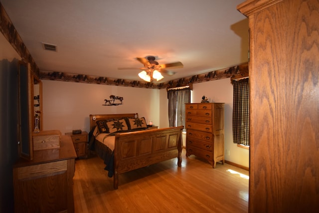 bedroom featuring hardwood / wood-style flooring and ceiling fan