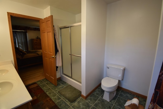 bathroom featuring tile patterned floors, vanity, an enclosed shower, and toilet