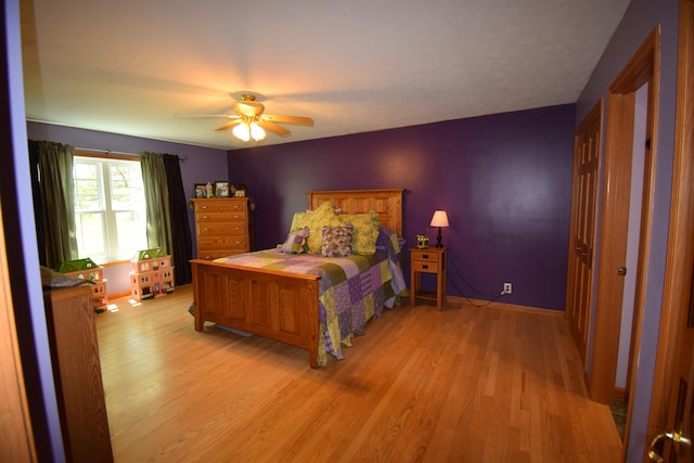 bedroom with ceiling fan and light wood-type flooring