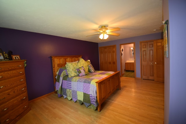 bedroom featuring light wood-type flooring, connected bathroom, and ceiling fan