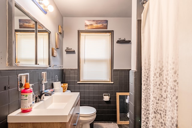 bathroom featuring a shower with curtain, vanity, tile walls, and toilet