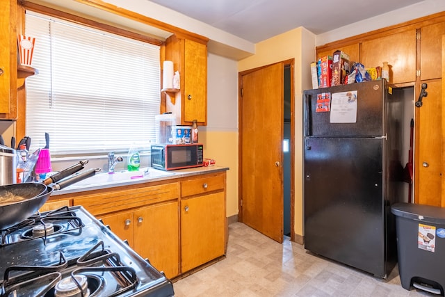 kitchen featuring black appliances and sink