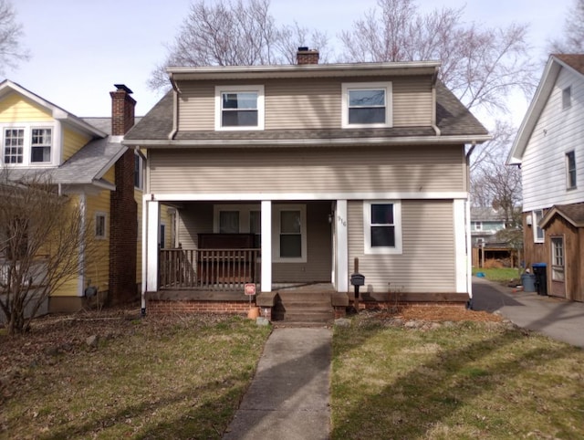 view of front facade with a porch and a front lawn