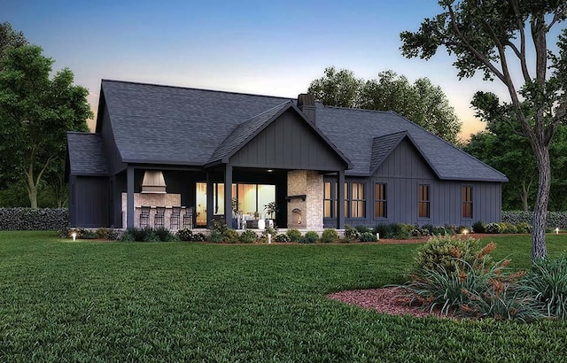 view of front of home featuring a lawn and exterior bar