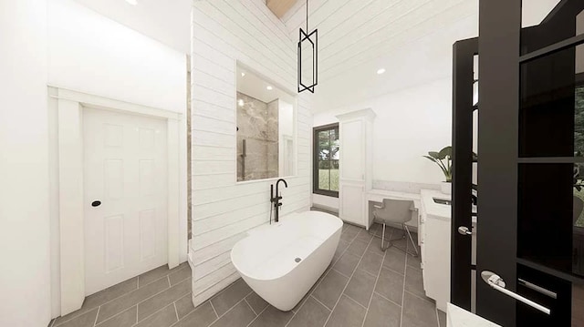 bathroom with tile patterned flooring, vanity, and a tub to relax in