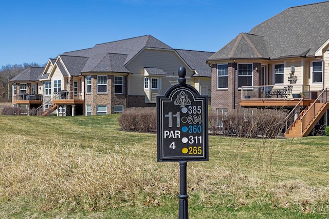 12258 Tullymore Dr, Stanwood, MI 49346 - exterior view of brick siding, stairs, and a downspout