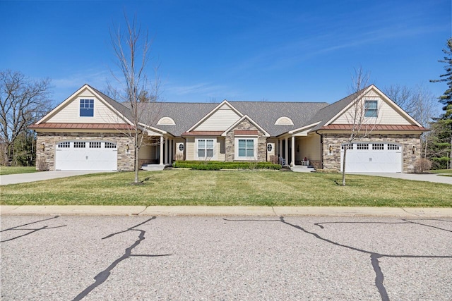 12258 Tullymore Dr, Stanwood, MI 49346 - craftsman-style house with stone siding, driveway, a garage, a front yard, and a standing seam roof