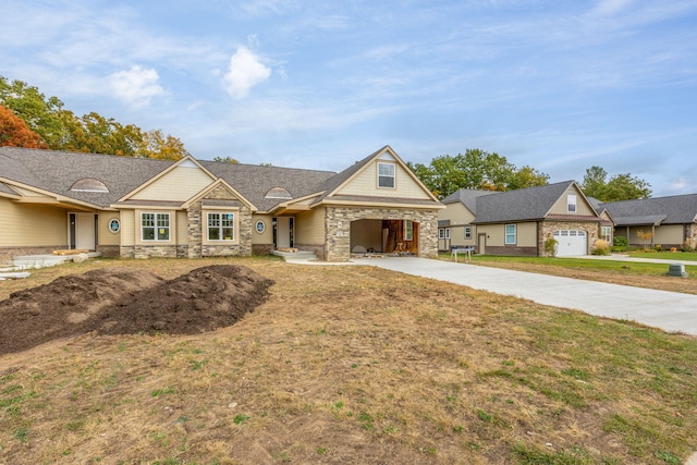 craftsman-style house with a garage and a front lawn