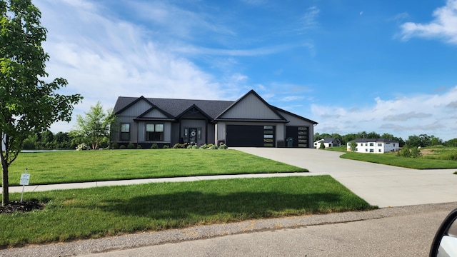 view of front of home with a front yard and a garage