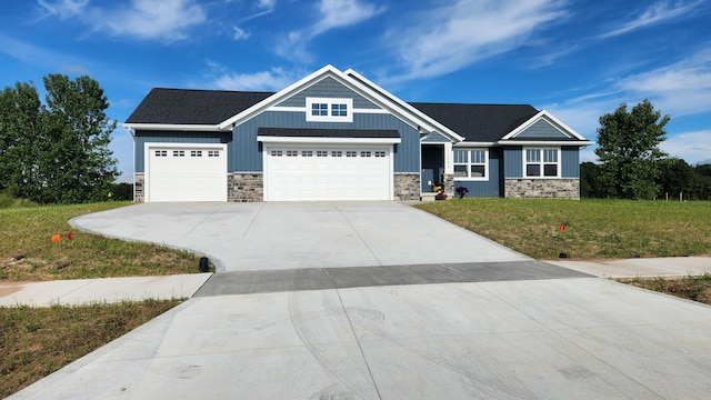 craftsman-style home featuring a garage and a front lawn