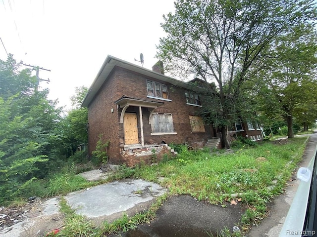 9021 Lawton St, Detroit, MI 48206 - view of front of house featuring brick siding and a chimney