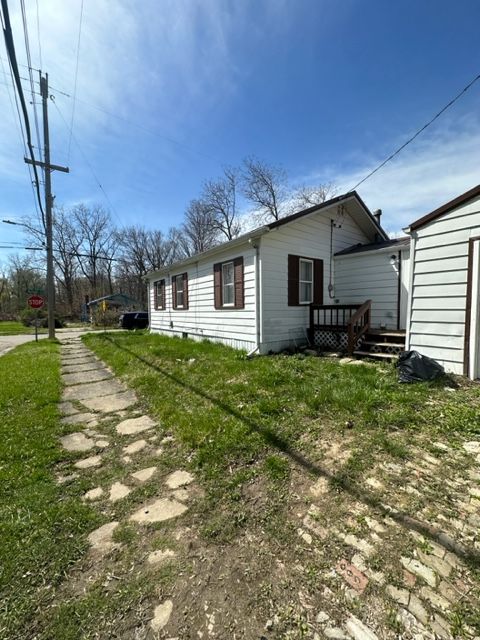 view of side of home with a deck and a yard