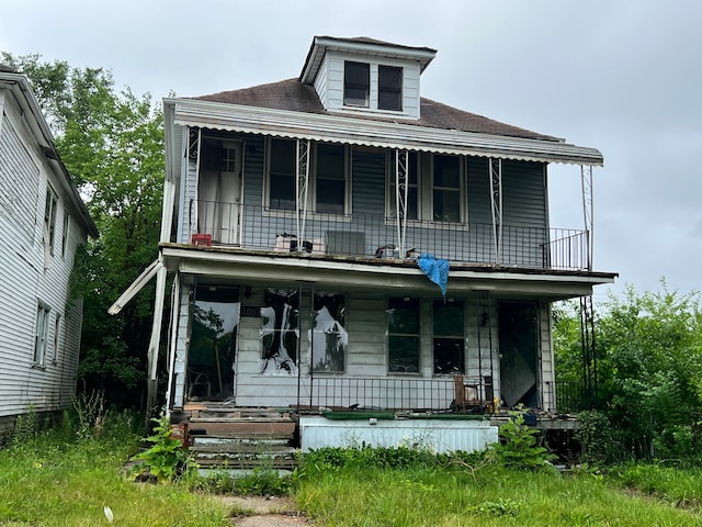 view of front of home featuring a porch and a balcony