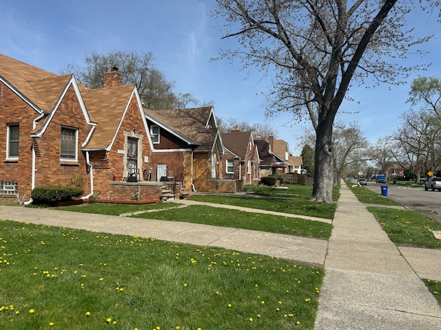 view of side of home with a lawn