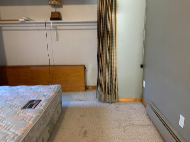 carpeted bedroom with baseboard heating