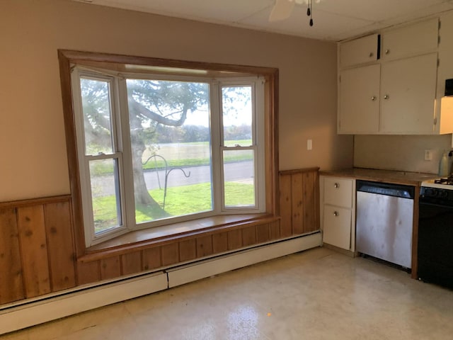 412 N Darling Ave, Fremont, MI 49412 - kitchen with stainless steel dishwasher, a baseboard heating unit, wainscoting, white cabinetry, and a ceiling fan