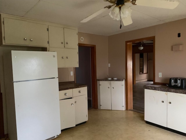 kitchen featuring white cabinets, white fridge, and ceiling fan