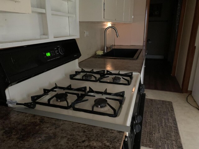 412 N Darling Ave, Fremont, MI 49412 - kitchen with range with gas cooktop, a sink, and white cabinets
