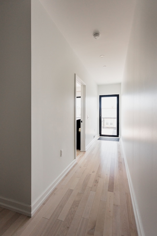 hallway with light hardwood / wood-style flooring