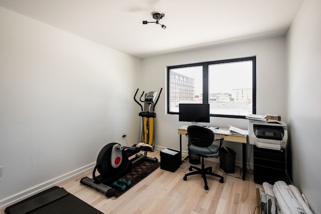 home office with light hardwood / wood-style floors