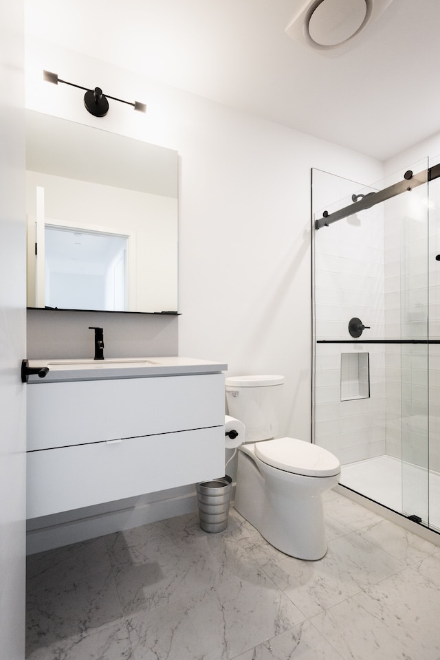 bathroom featuring vanity, toilet, and an enclosed shower