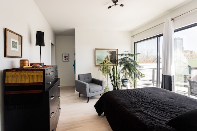 bedroom featuring light hardwood / wood-style floors and access to exterior