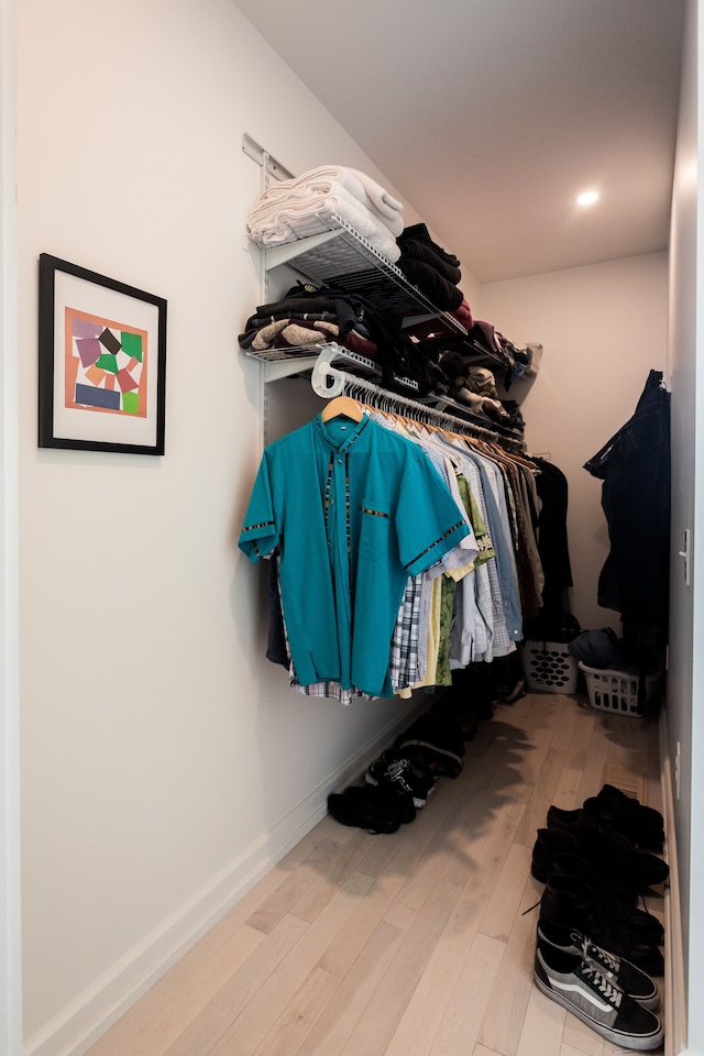 walk in closet featuring light hardwood / wood-style flooring