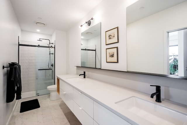 bathroom featuring toilet, an enclosed shower, and vanity