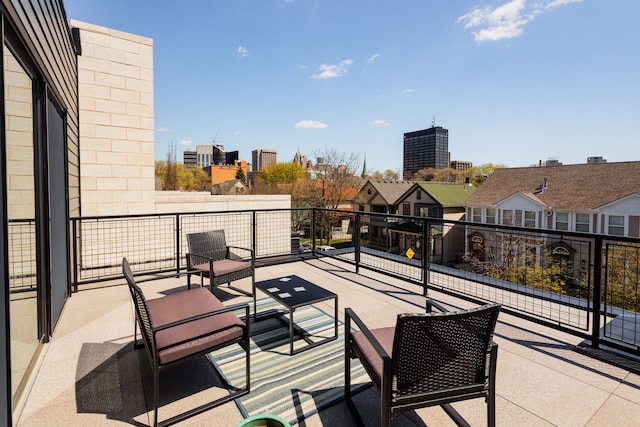 view of patio featuring a balcony