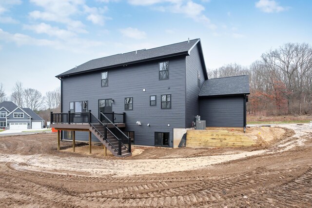 back of house with central AC and a deck