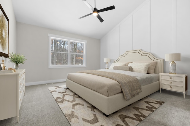 bedroom with light carpet, ceiling fan, vaulted ceiling, and baseboards