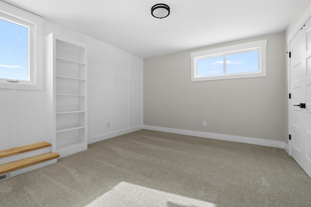 unfurnished bedroom featuring carpet, visible vents, and baseboards