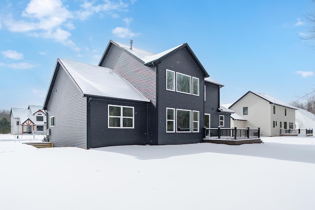 snow covered property featuring a deck