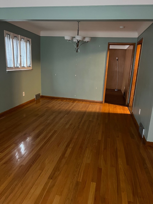 spare room with dark hardwood / wood-style floors