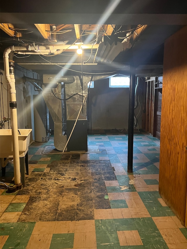 basement featuring sink and heating unit