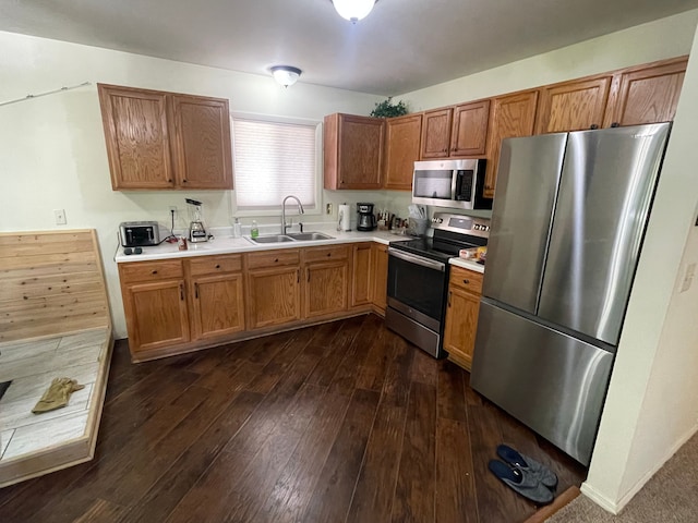 kitchen featuring dark hardwood / wood-style flooring, sink, and stainless steel appliances