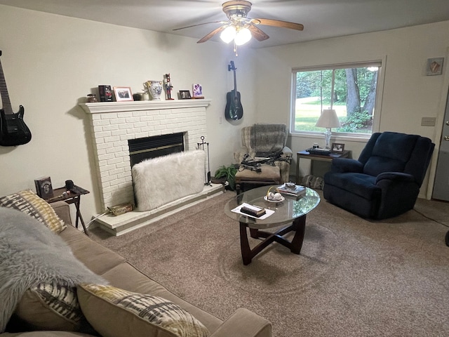 carpeted living room with ceiling fan and a brick fireplace