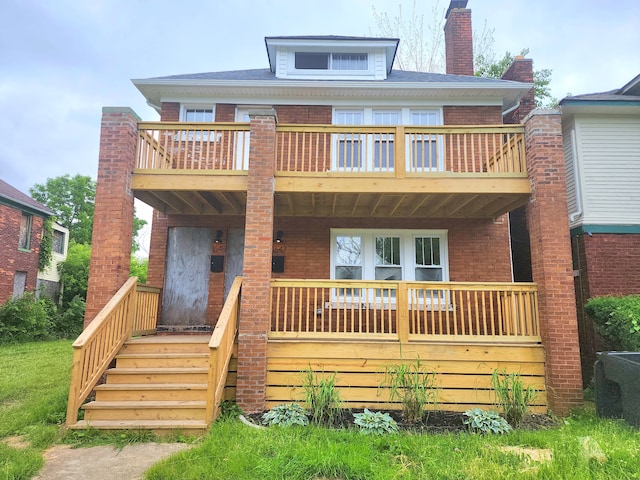 rear view of property with a balcony