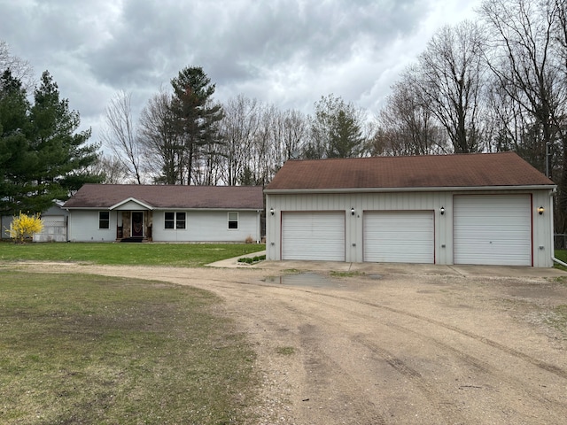 view of front of property with a garage and a front lawn