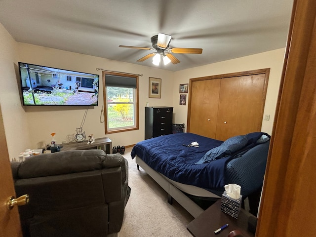 bedroom with ceiling fan, carpet flooring, and a closet