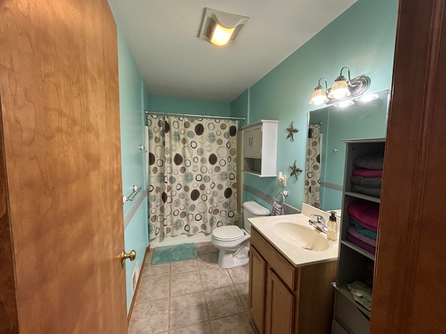 bathroom featuring vanity, tile patterned flooring, and toilet