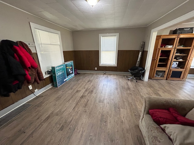 living room with wood-type flooring and wood walls