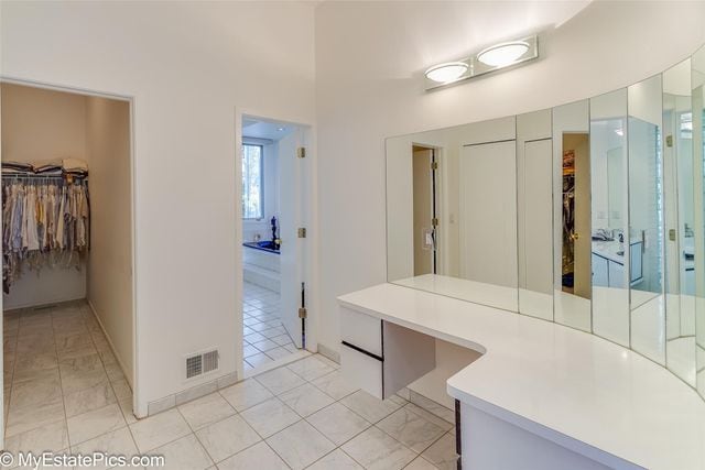 bathroom with tile patterned flooring and vanity